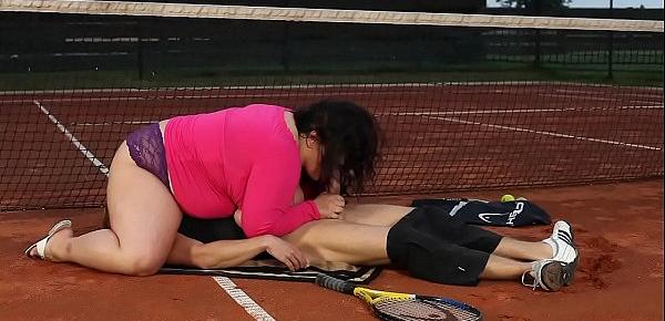  Obese woman facesits on her trainer at the tennis court